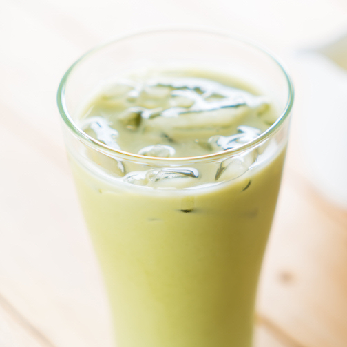 iced matcha latte on wood background